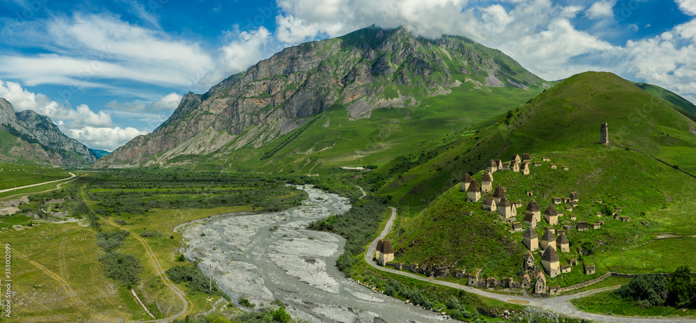 Aerial panorama of Dead Town Dargavs In North Ossetia. The ancient cemetery of the Alans. Many small stone mausoleums, standing on the side of a mountain.
