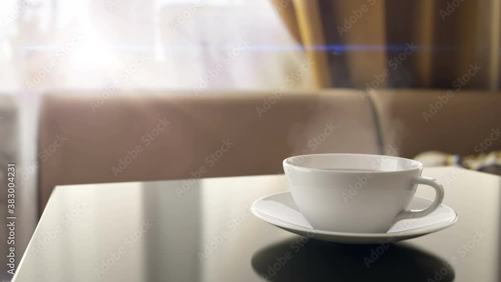 Cup of steaming morning coffee on the kitchen table at home. Early morning breakfast with warm drink from roasted natural beans helps to wake up and get ready for daily tasks and work, 3d animation. Cup of steaming morning coffee on the kitchen table at home. Early morning breakfast with warm drink from roasted natural beans helps to wake up and get ready for daily tasks and work, 3d animation.