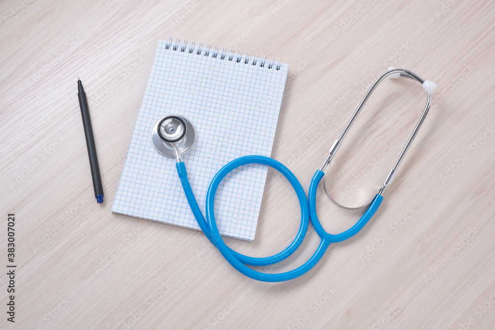 medicines, pills, medical stethoscope and notepad for notes on the table, disease diagnosis concept medicines, pills, medical stethoscope and notepad for notes on the table, disease diagnosis concept
