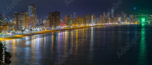 Breathtaking panoramic view of summer resort with beach and famous skyscrapers. Beautiful  evening lights of big city. Costa Blanca. City of Benidorm, Alicante, Valencia, Spain. © Sodel Vladyslav