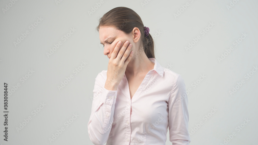 A tired woman feels pain in her teeth A tired woman feels pain in her teeth