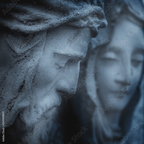 Very ancient stone statue of Jesus Christ and Virgin Mary. Close up.