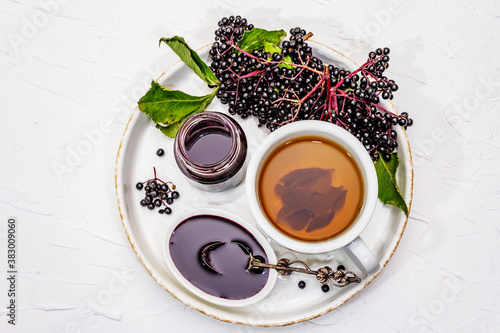 Elderberry jam from ripe berries and hot tea