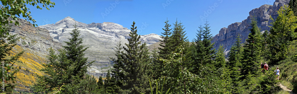 Ordesa and Monte Perdido National Park in the Spanish Pyrenees. A family hikes along the trail towards the Circo de Soaso, with Monte Perdido rising high.. Ordesa and Monte Perdido National Park in the Spanish Pyrenees. A family hikes along the trail towards the Circo de Soaso, with Monte Perdido rising high..