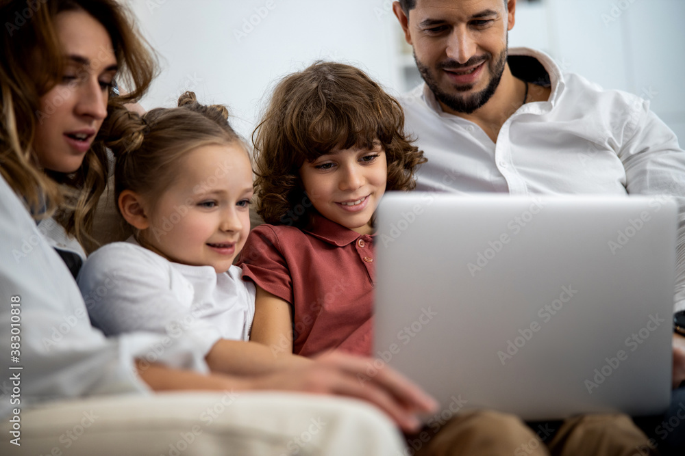 Family looking at something on the laptop Family looking at something on the laptop