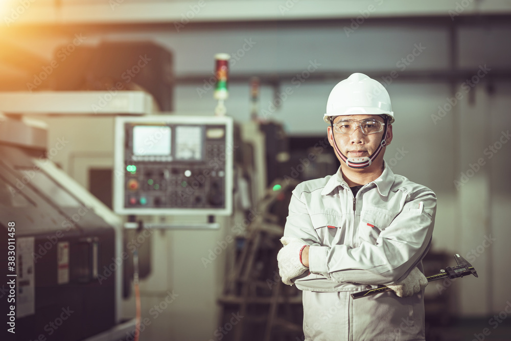 The worker in uniform construction machine factory The worker in uniform construction machine factory