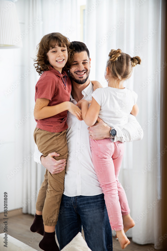 Father holding his children in his arms Father holding his children in his arms
