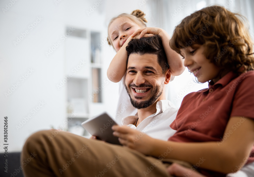 Father and son watching something on the tablet Father and son watching something on the tablet