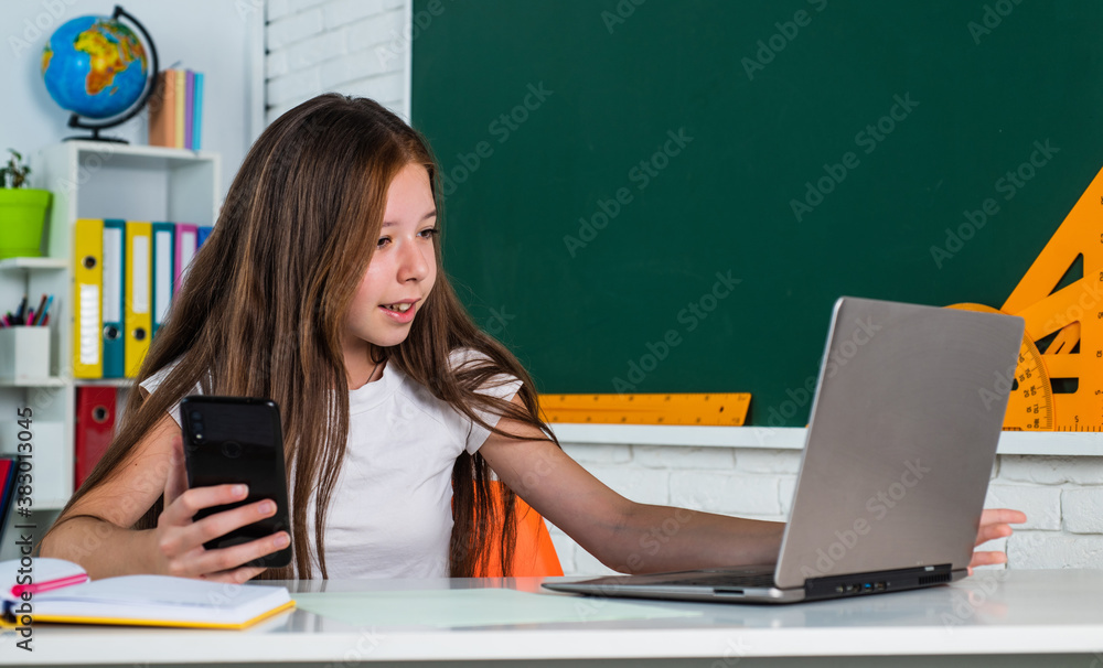 child in classroom school with computer and mobile phone, education online child in classroom school with computer and mobile phone, education online