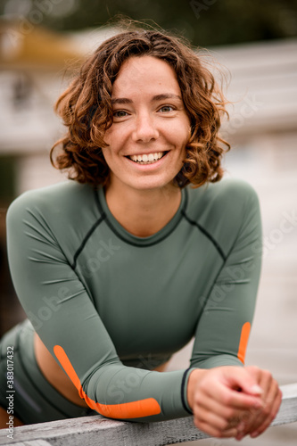 portrait of smiling young woman with curly hair in nylon swimsuit Free Download portrait of smiling young woman with curly hair in nylon swimsuit - GFXLoad