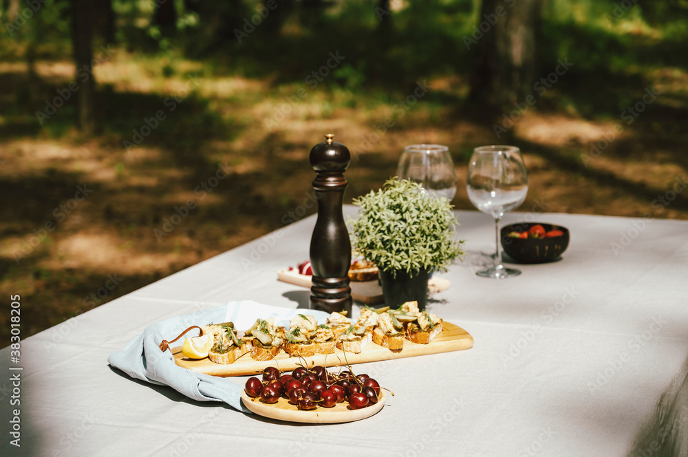 Naklejka Restaurant looking table with snack in the forest