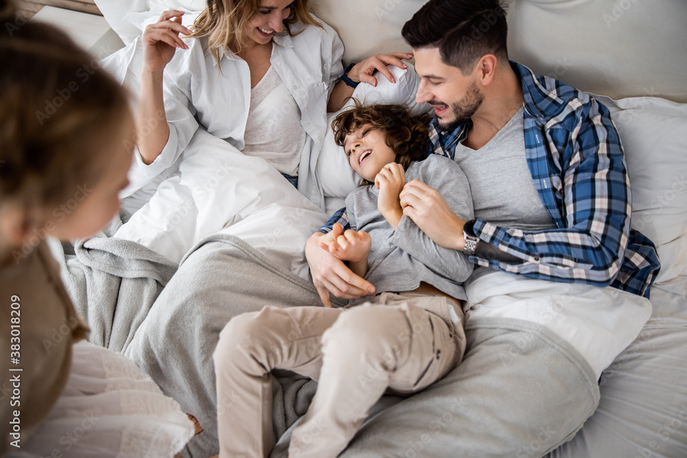 Couple with their children being playful at home Couple with their children being playful at home