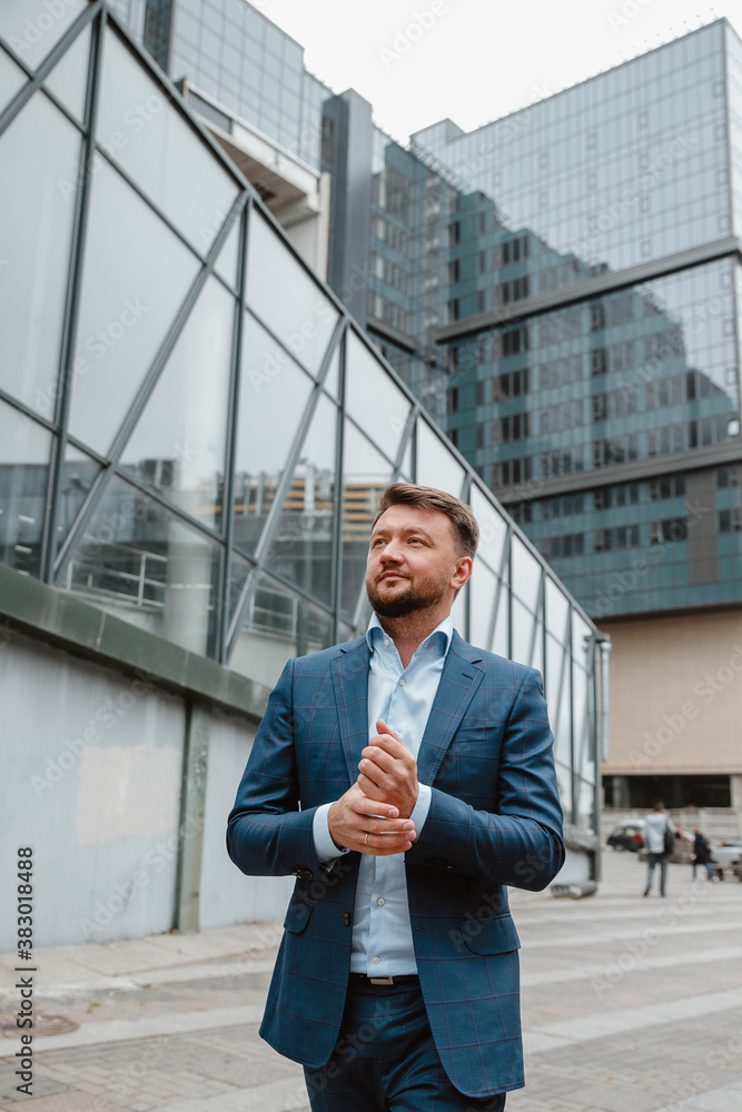 Russian businessman in a suit in the background of the city Russian businessman in a suit in the background of the city