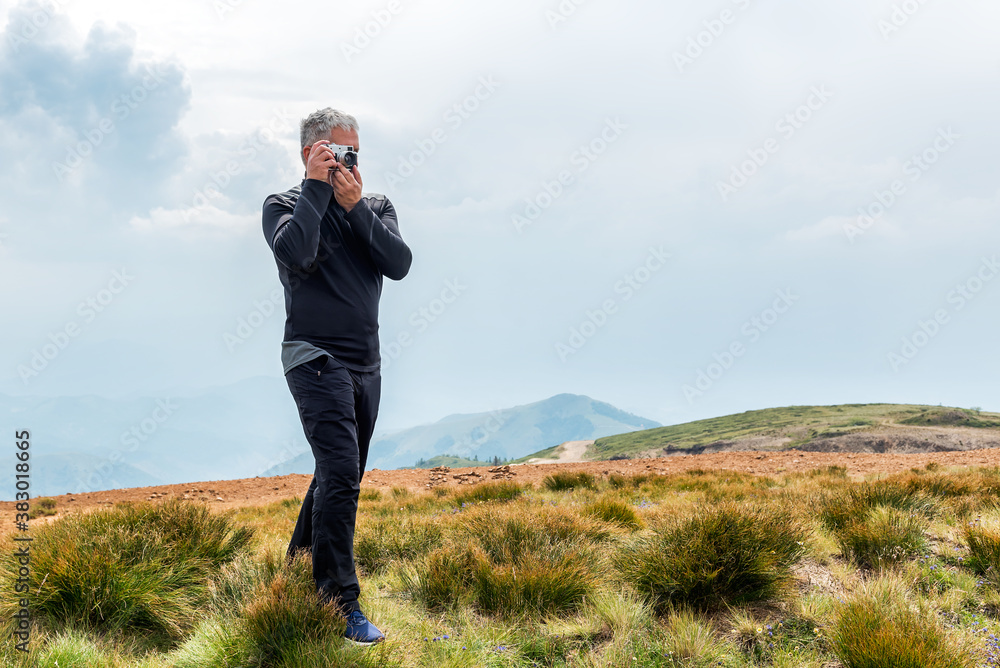 Photographer with old analog camera at a Mountain top. Mountain landscape view. Mountain layers landscape. 

Meadows and mountains landscape. Blue mountains layers landscape. Top of the Mountains
