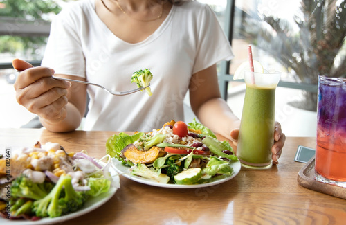 Selective focus of woman with Broccoli and salad which she make a Intermittent fasting with a Healthy food of salad and detox drink ,Healthy lifestyle Concept. photo