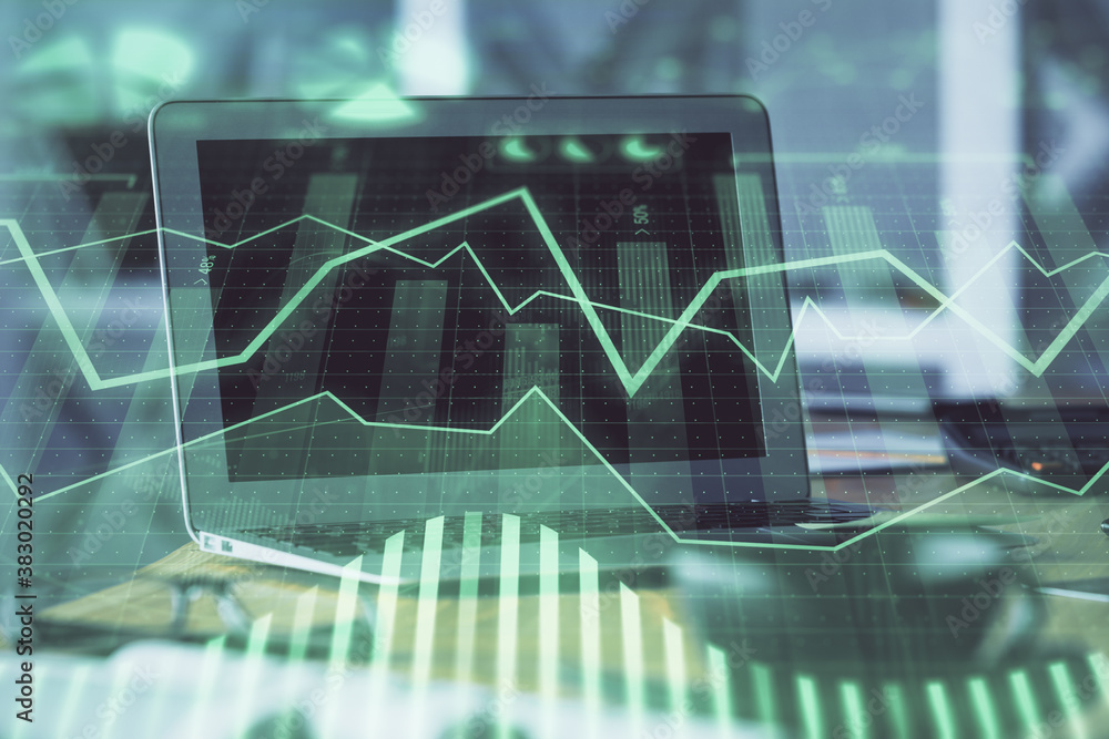Forex graph hologram on table with computer background. Multi exposure. Concept of financial markets. Forex graph hologram on table with computer background. Multi exposure. Concept of financial markets.