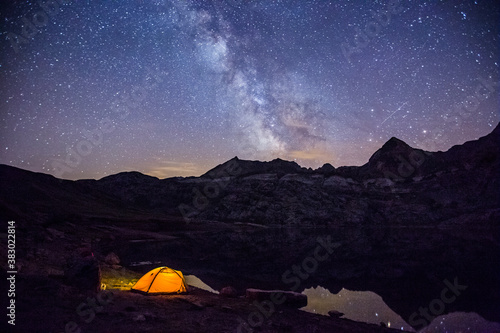 Summer night under Milky way in Ibon De Estanes lake, Aragon Pyrenees, Spain