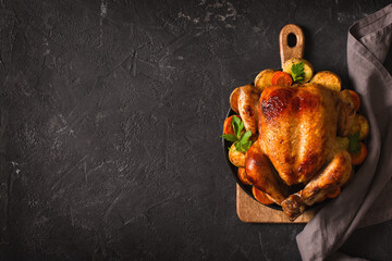 Fall thanksgiving table with roasting chicken or turkey food on black background