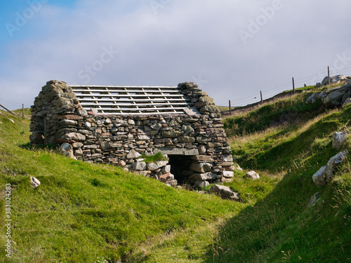 One of three abandoned horizontal water mills at Huxter in Shetland - the construction uses drystone walls photo