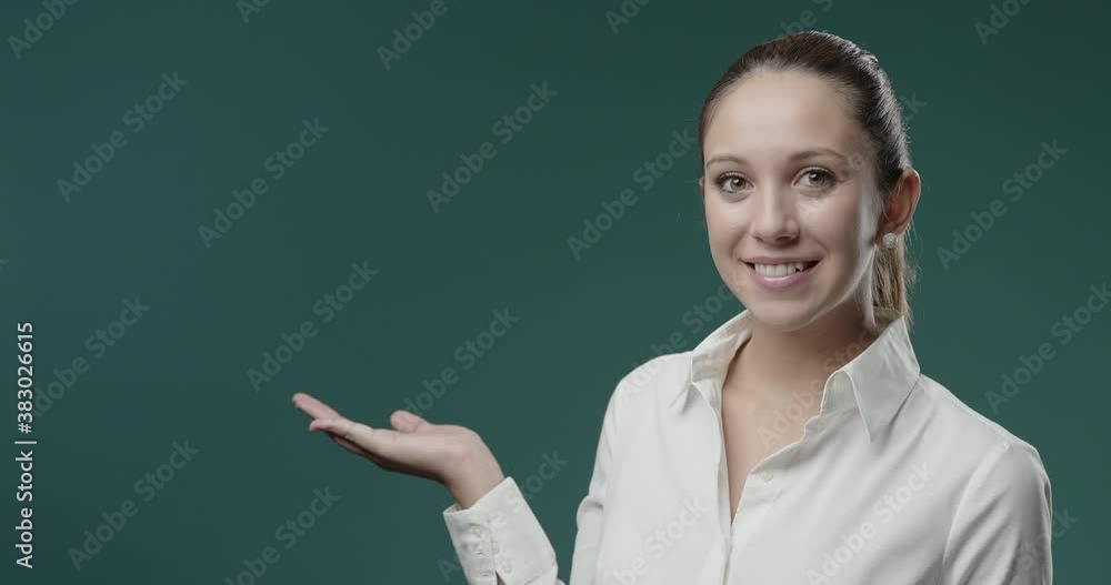 Confident businesswoman presenting something with her hand Confident businesswoman presenting something with her hand
