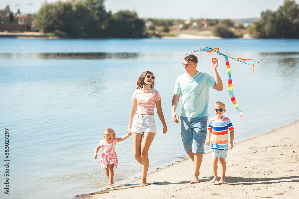 Happy family having fun on the beach. Summer concept Happy family having fun on the beach. Summer concept