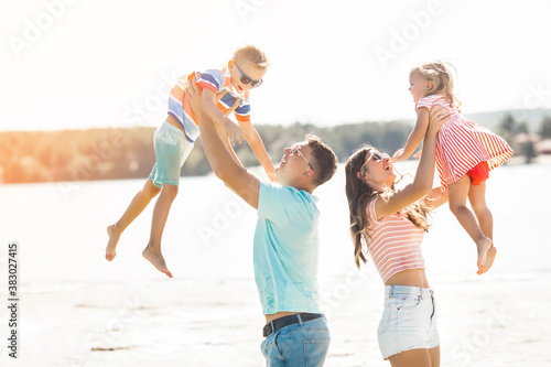 Happy family having fun on the beach. Summer concept