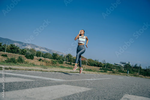 A beautiful woman runing on street in sportswear.