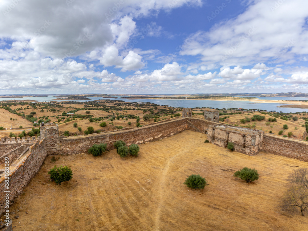 Mora medieval castle view, with Alentejo region tourist destination landscape in the background, Portugal.