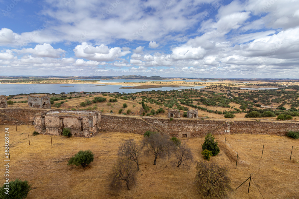 Mora medieval castle view, with Alentejo region tourist destination landscape in the background, Portugal.