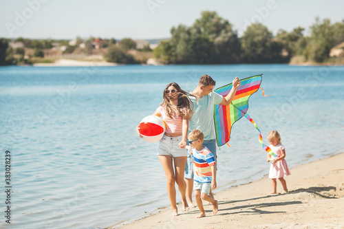 Happy family having fun on the beach. Summer concept