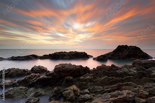 Sea and rocks with beautiful sunset in the background