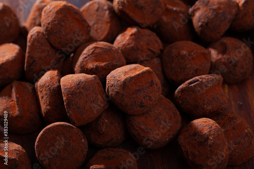 Close up view of delicious chocolate candies truffles in cocoa powder