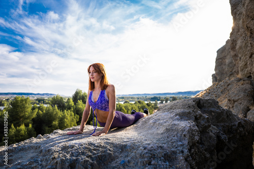 Woman practicing yoga on the mountains. Healthy lifestyle and relaxation concept