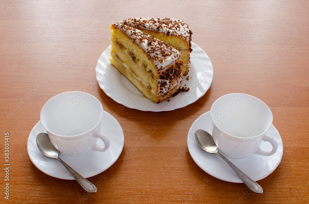 Two white cups of tea and cake. Two white cups of tea and cake.