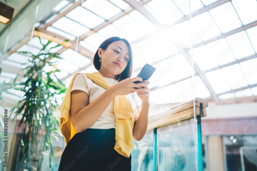 Pretty asian female in smart casual wear holding smartphone connected to 4G internet typing and sending text messages,businesswoman using banking app on mobile phone making money transaction