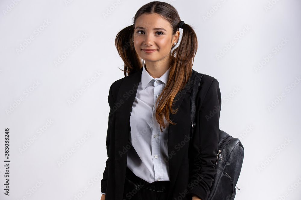 Beautiful caucasian girl in white blouse and black jacket with handbag looking on camera Beautiful caucasian girl in white blouse and black jacket with handbag looking on camera