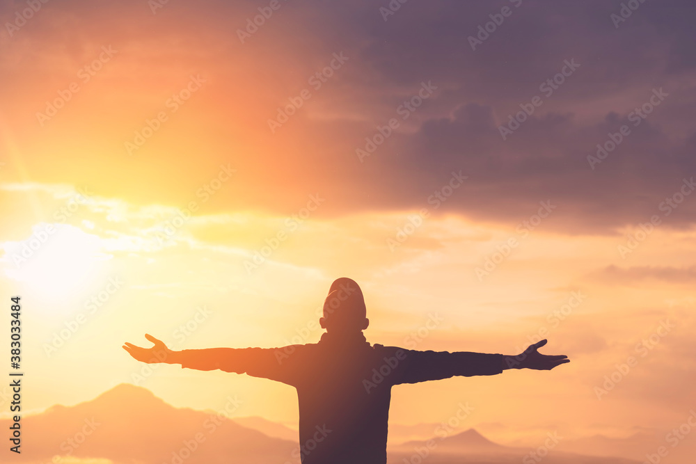Fototapeta premium Copy space of man rise hand up on top of mountain and sunset sky abstract background.