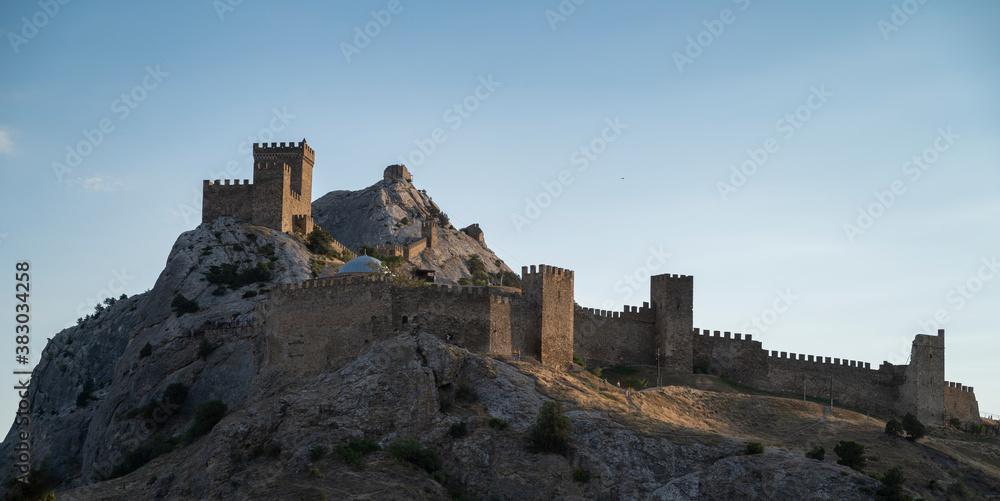 ruins of the fortress, The old defensive wall of the fortress on the mountain, against the blue sky