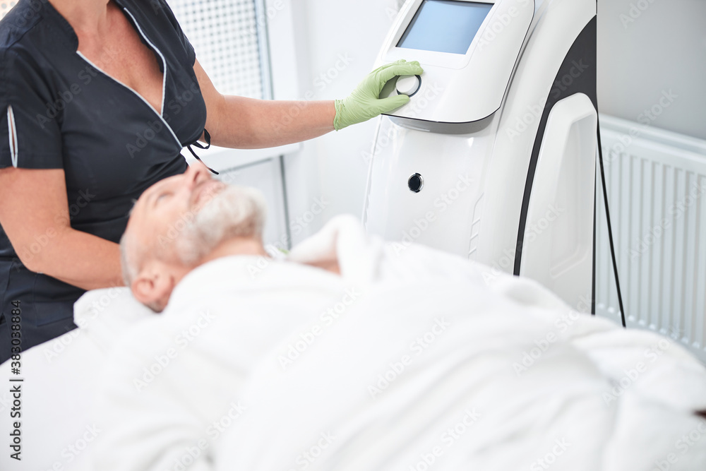 Relaxed elderly man waiting for spa specialist to start procedures Relaxed elderly man waiting for spa specialist to start procedures