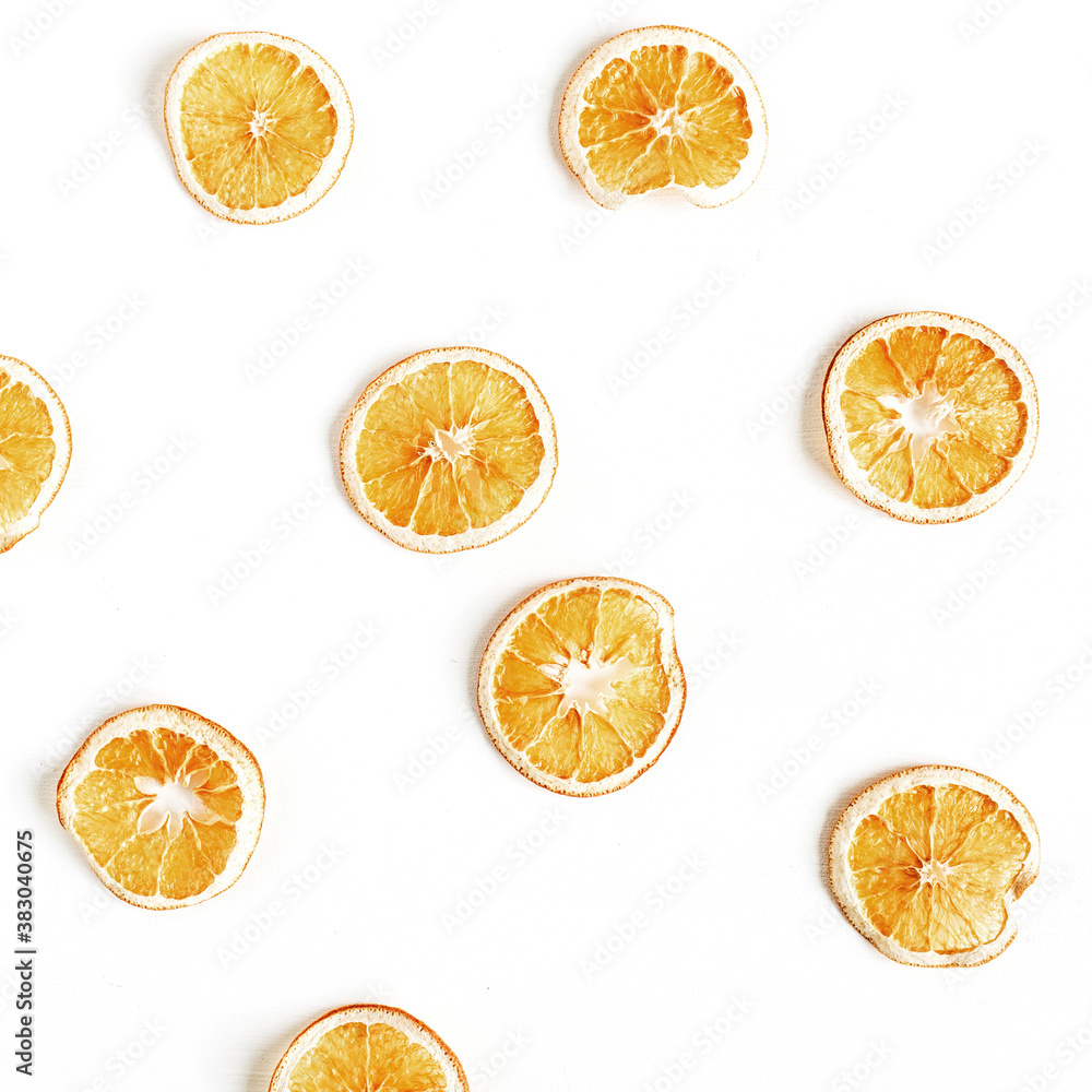 Obraz premium Colorful fruit pattern of dried oranges on white background. Top view, flat lay. Minimal and creative composition.