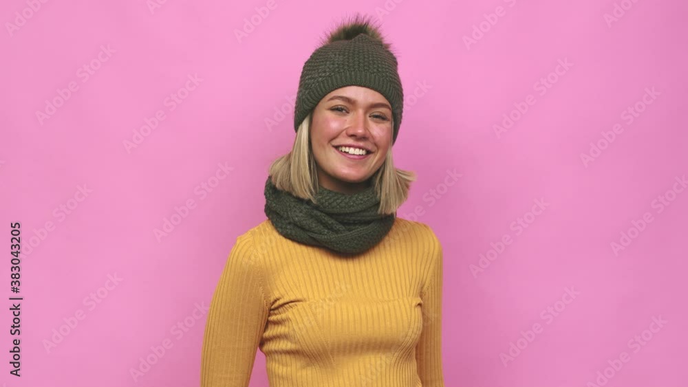 Young cute woman winter clothes pointing with finger at you as if inviting come closer Young cute woman winter clothes pointing with finger at you as if inviting come closer