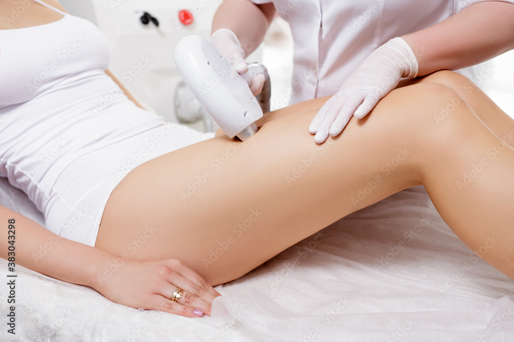 Fototapeta premium laser epilation and beauty concept - close up of hair removal procedure on legs