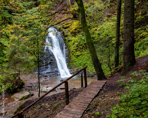 Wonderful waterfall on the mountain river Carpathians. Hurkalo Waterfall, Carpathian Mountains, National Park of Skole Beskydy, Ukraine. Carpathian river, fast current, crystal water. Long exposu photo