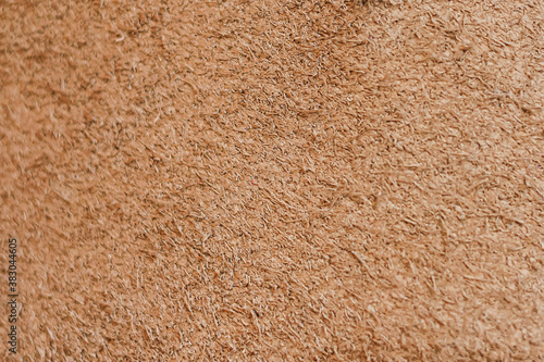 Natural brown suede leather background. Closeup. Selective focus. Copy space.