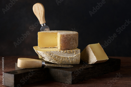 Set of hard cheeses gruyere and manchego on dark background. Still life of  wine snacks photo