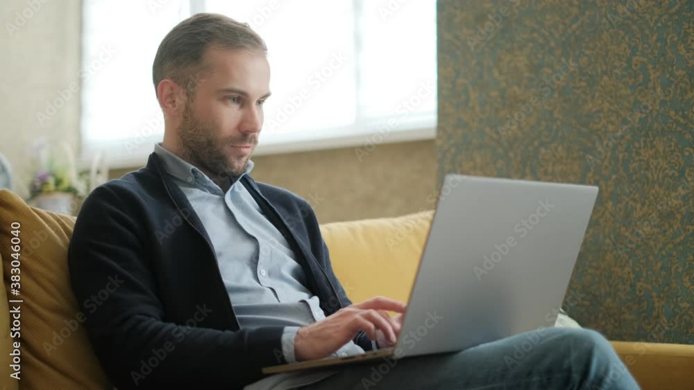 Remote Job. A man is working with documents on laptop remotely at home. A business man is using computer and typing text on the keyboard. Quarantine and isolation concept Remote Job. A man is working with documents on laptop remotely at home. A business man is using computer and typing text on the keyboard. Quarantine and isolation concept