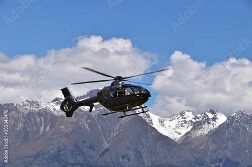 The view of mountains with a helicopter in Queenstown, New Zealand