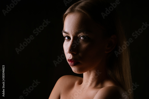 Close-up portrait of a beautiful young woman , dark photo