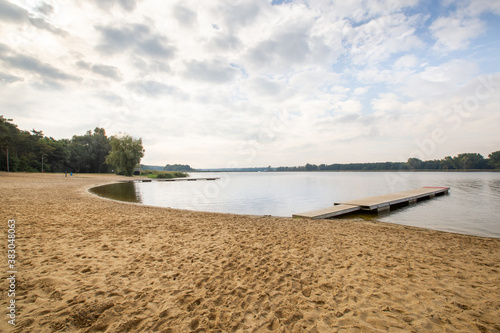 Large lake  clean beach with no people  tourist season  summer