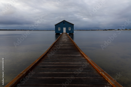 Blue boat shed on a rainy morning on the Swan River in Perth, Western Australia